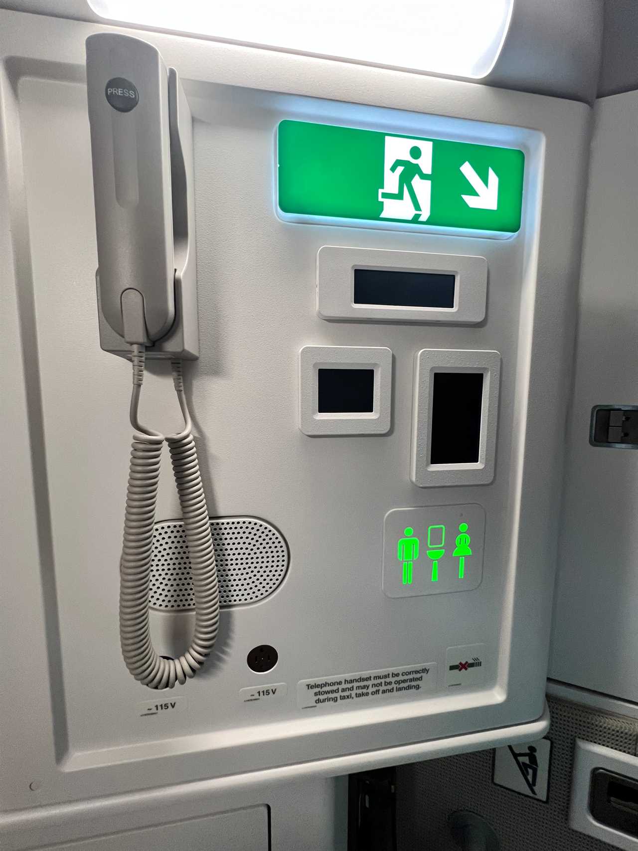 A telephone and emergency exit sign in the crew rest area of the Airbus A350.