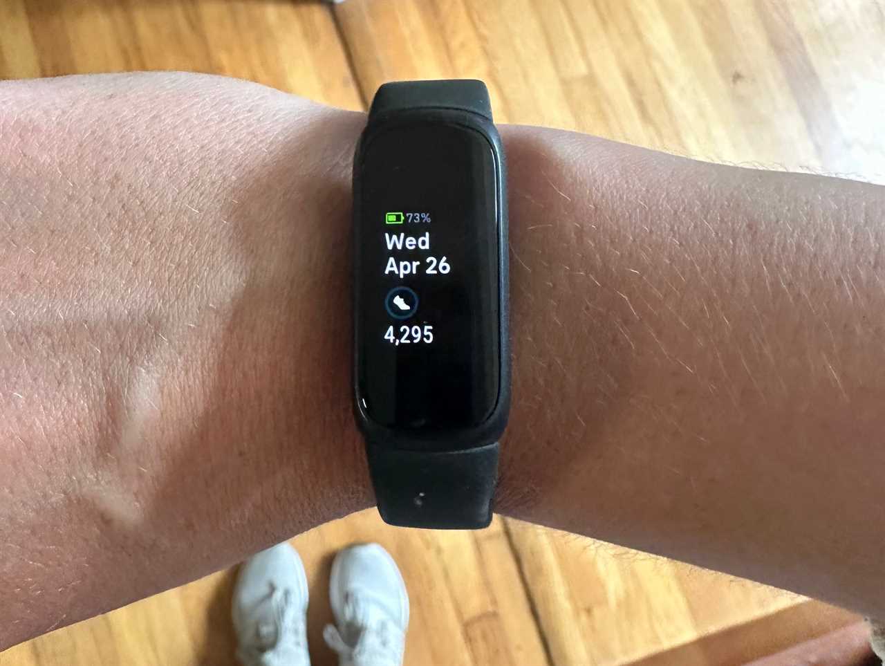 A person wearing a Fitbit Inspire 3 on their wrist.