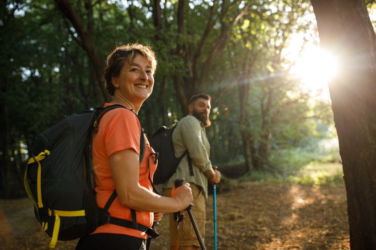 People turning and looking over shoulder during a relaxing forest hike