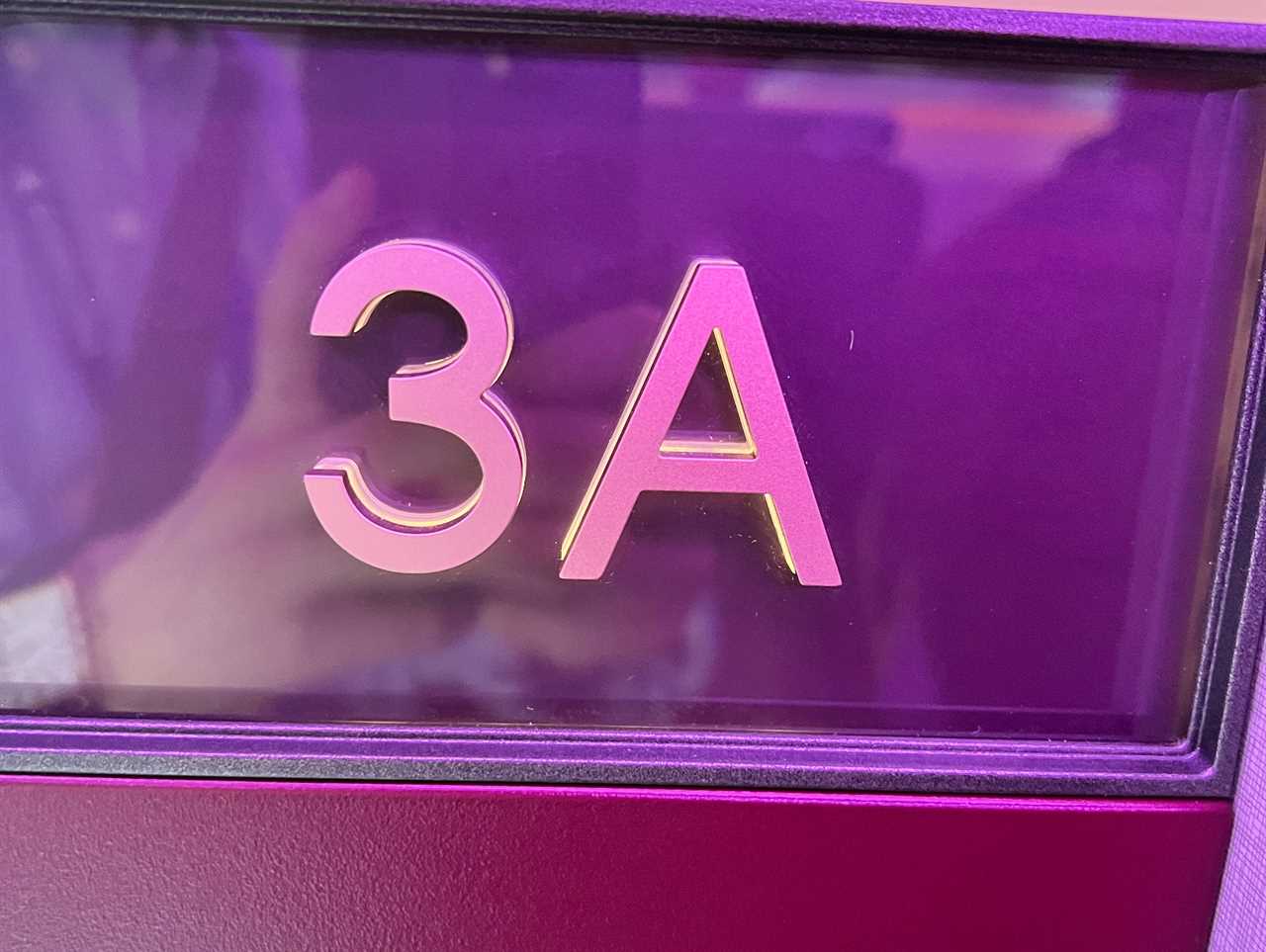 An embossed sign on a Qatar Airways Qsuite showing seat 3A