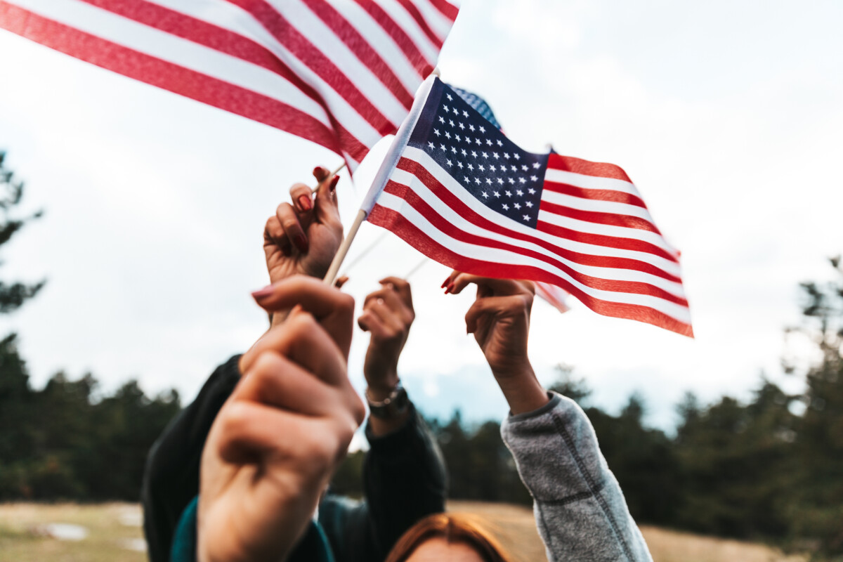 American flags raised over heads