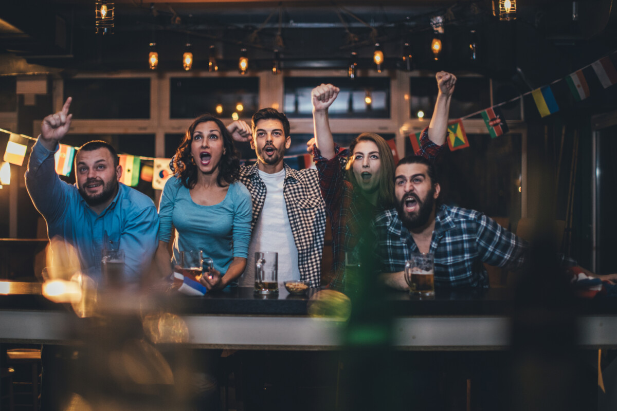 Friends cheering on their sports team in Grand Rapids