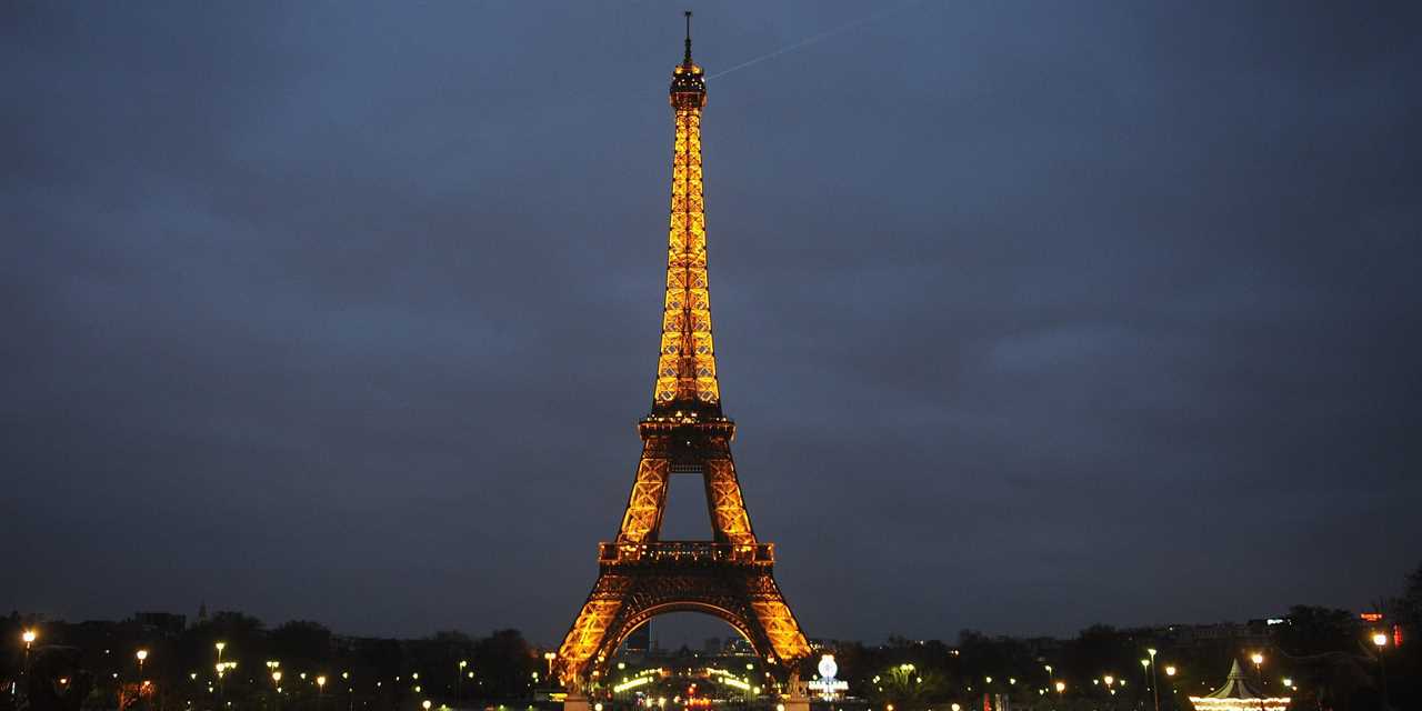 The Eiffel Tower, lit up against the night sky