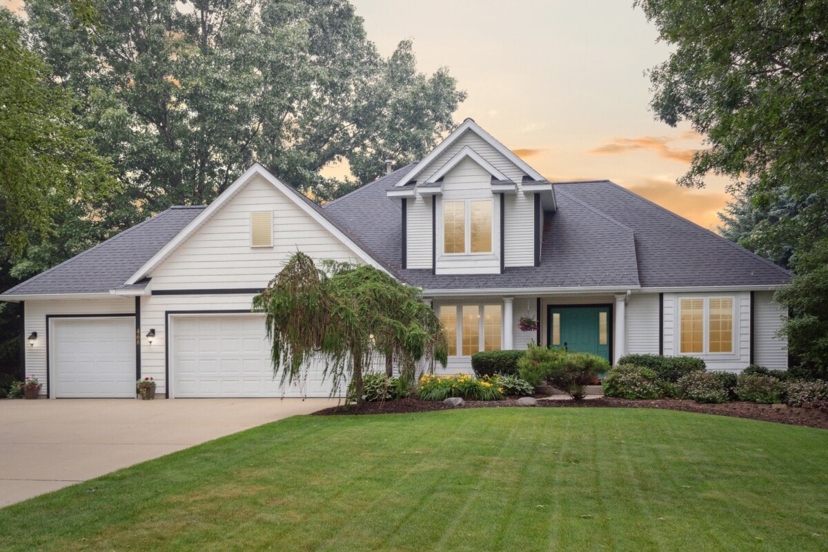 well manicured lawn white traditional style home