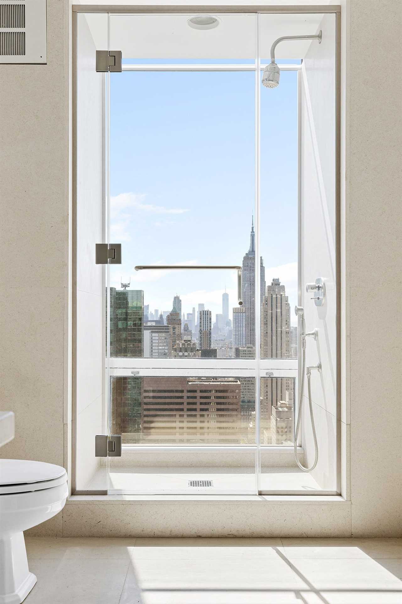 A walk-in shower with a floor-to-ceiling window.