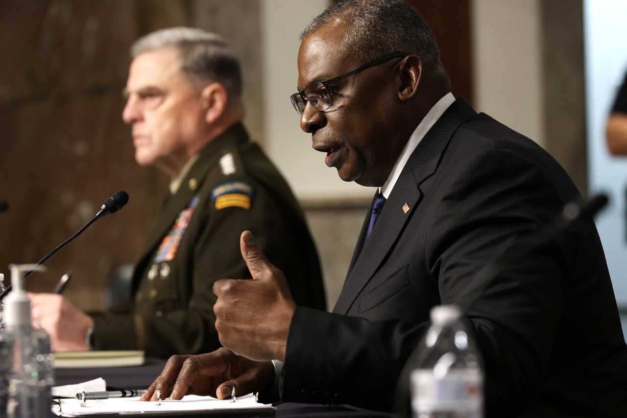 Gen. Mark Milley and Defense Secretary Lloyd Austin sitting at a table.