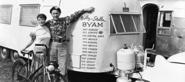 Stella and Wally Byam pose in front of an Airstream trailer.