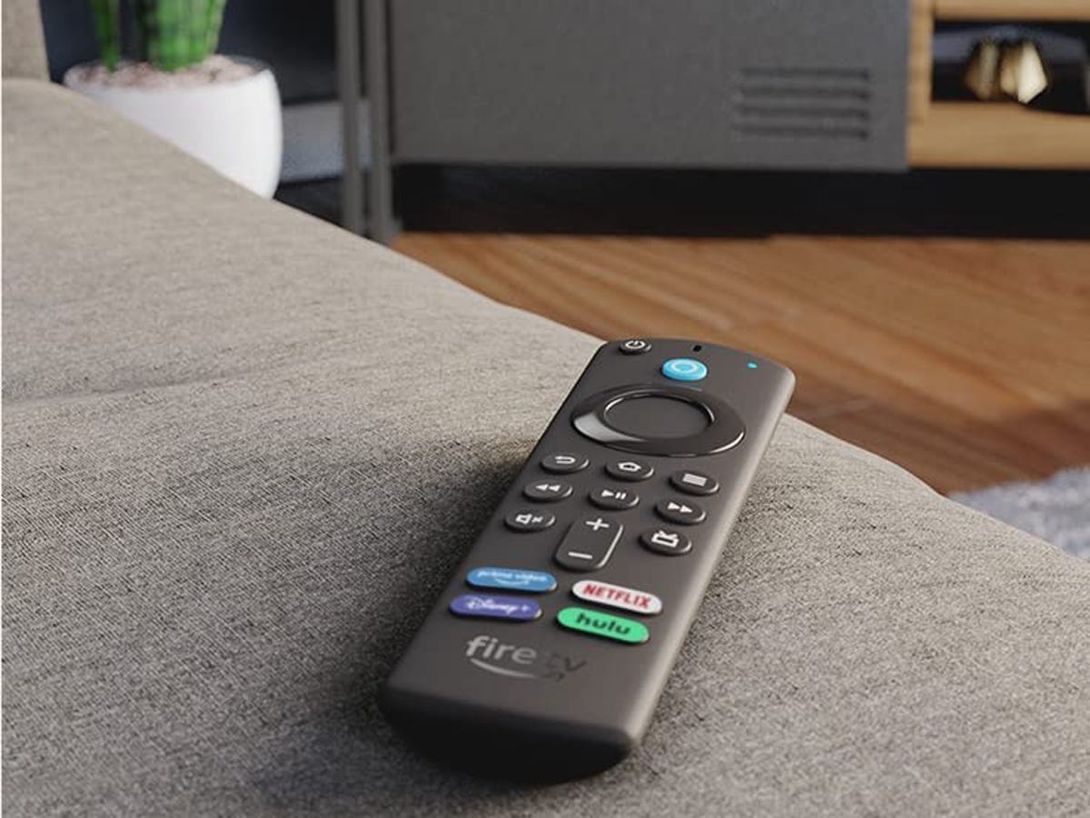 a Fire TV Stick 4K Max sits on a couch in a living space