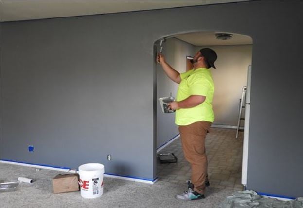 New commercial space - man painting interior of an apartment