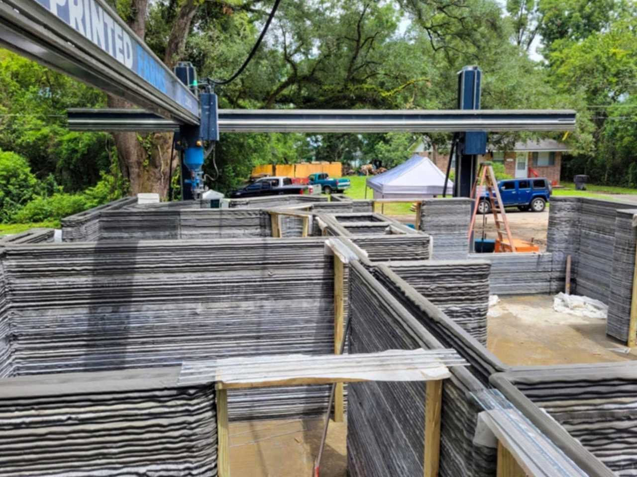 3D-printed walls being constructed outdoors