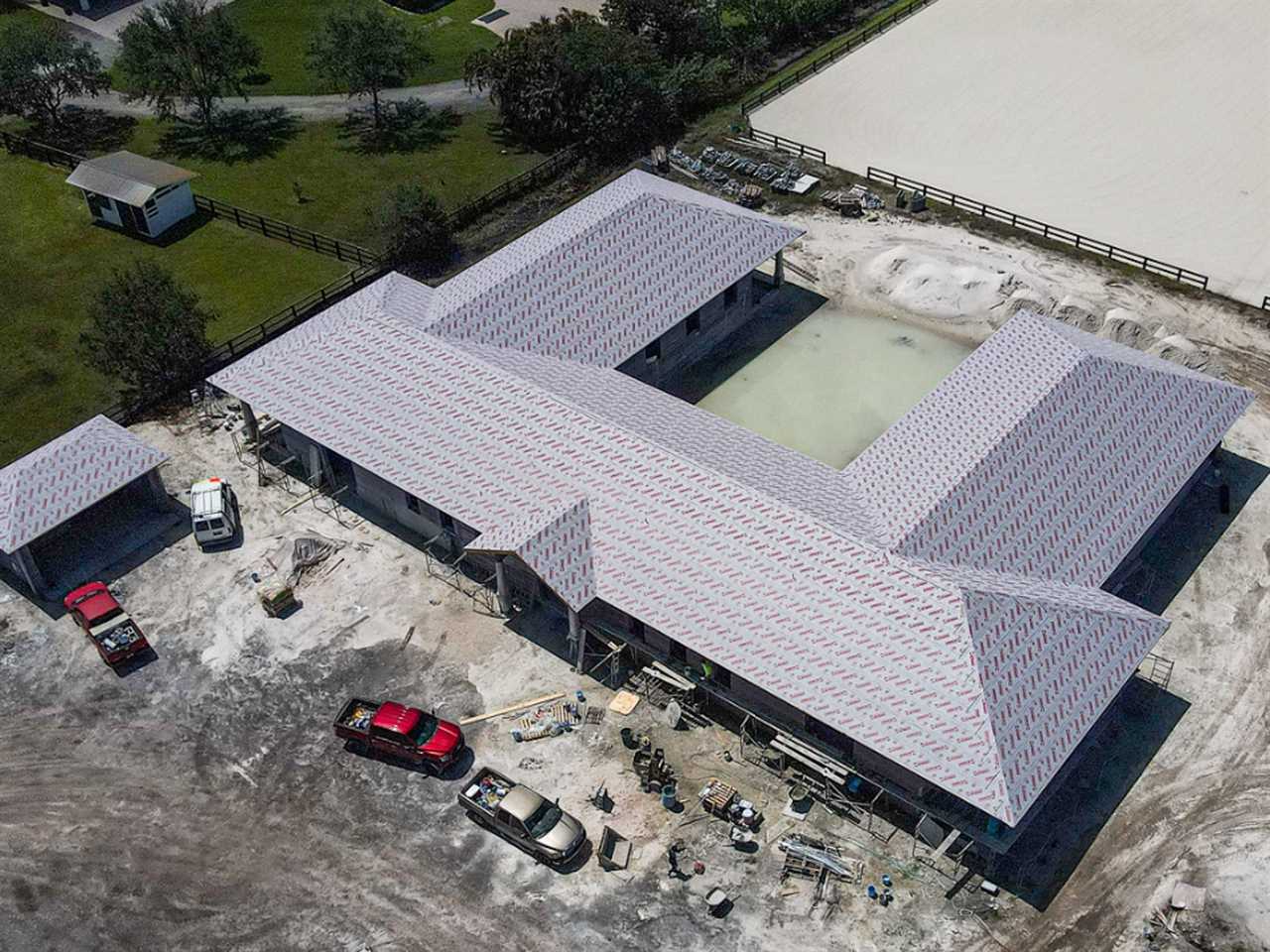 Exterior of Printed Farms' 3D-printed horse barn next to another printed building