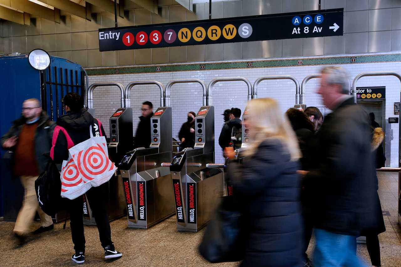 People walk through Times Square Subway Station on December 2, 2022 in New York City.