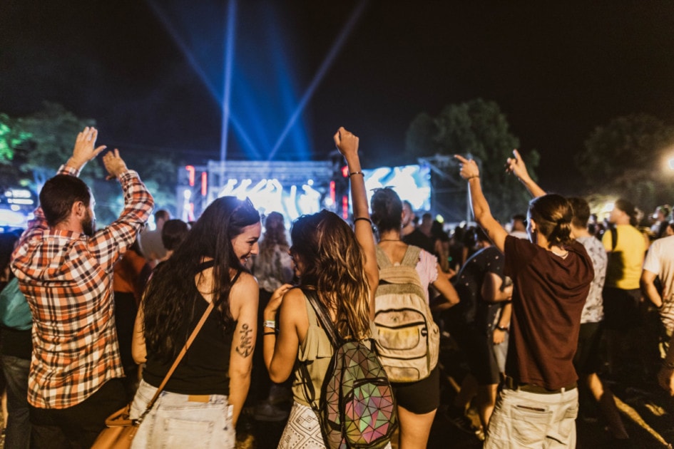 People enjoying a music festival at night.