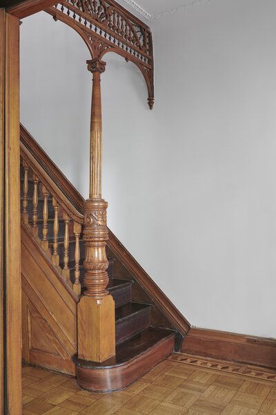 During the remodel with Lee, Serena and Andrew wanted to preserve and restore much of the surviving historic detail, like the inlaid wood floors and carved fretwork in the foyer.