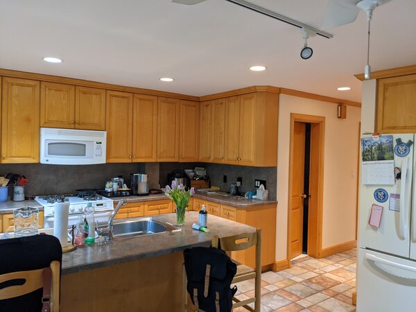 Before: The kitchen had been remodeled in the 90s and the finishes, like the faux-stone tile floors, didn’t align with the couple’s style.