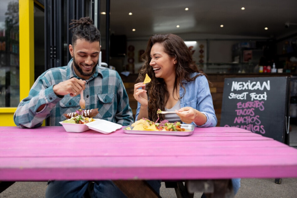 Loving couple looking happy eating tacos at a Mexican restaurant