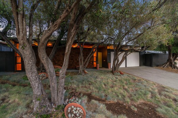 Spanning over 3,300 square feet, the home's expansive volume is cleverly understated from street view. Soaring trees surrounding the property offer plenty of privacy and shade.