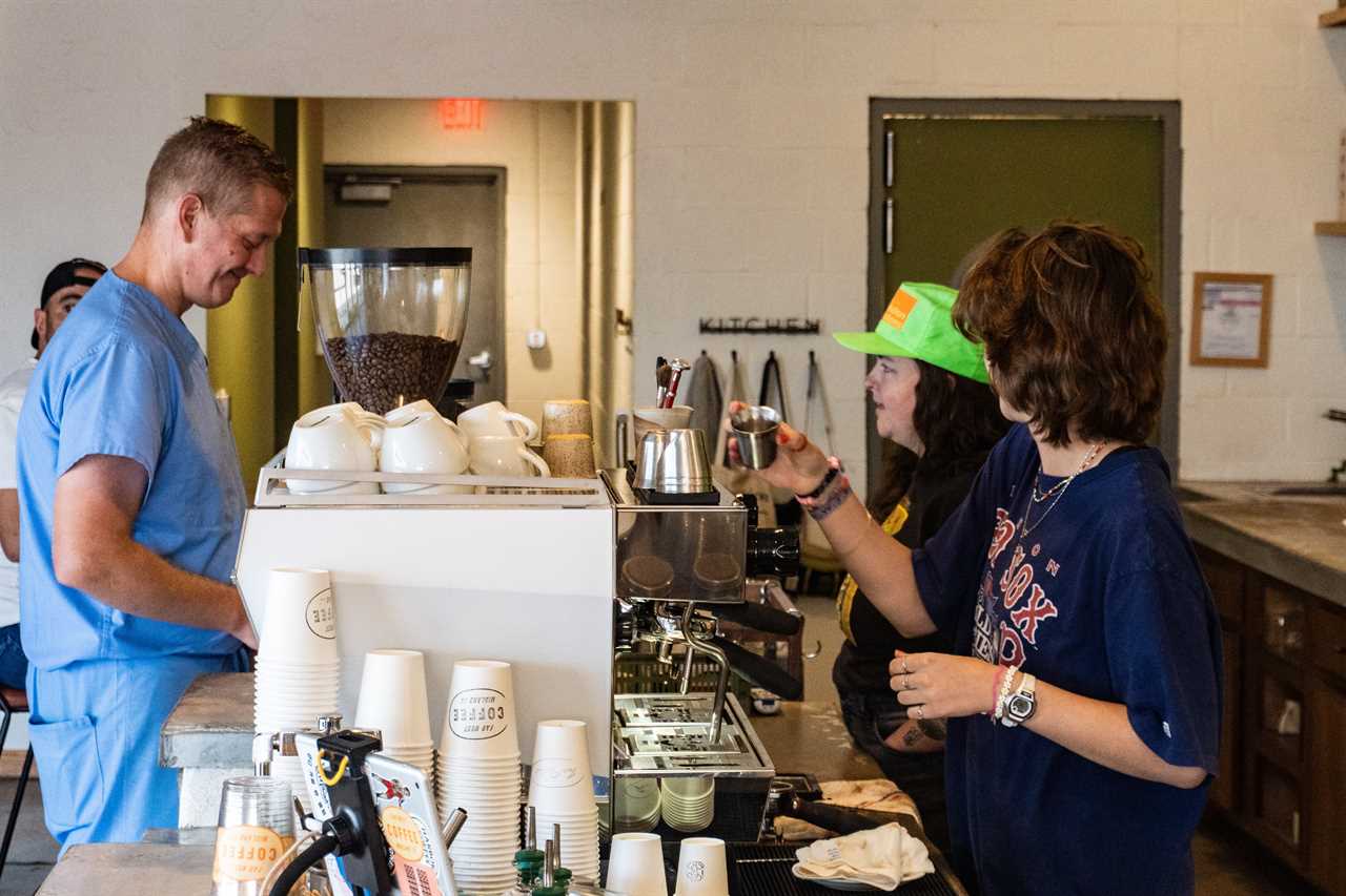 Baristas preparing coffee for a customer.