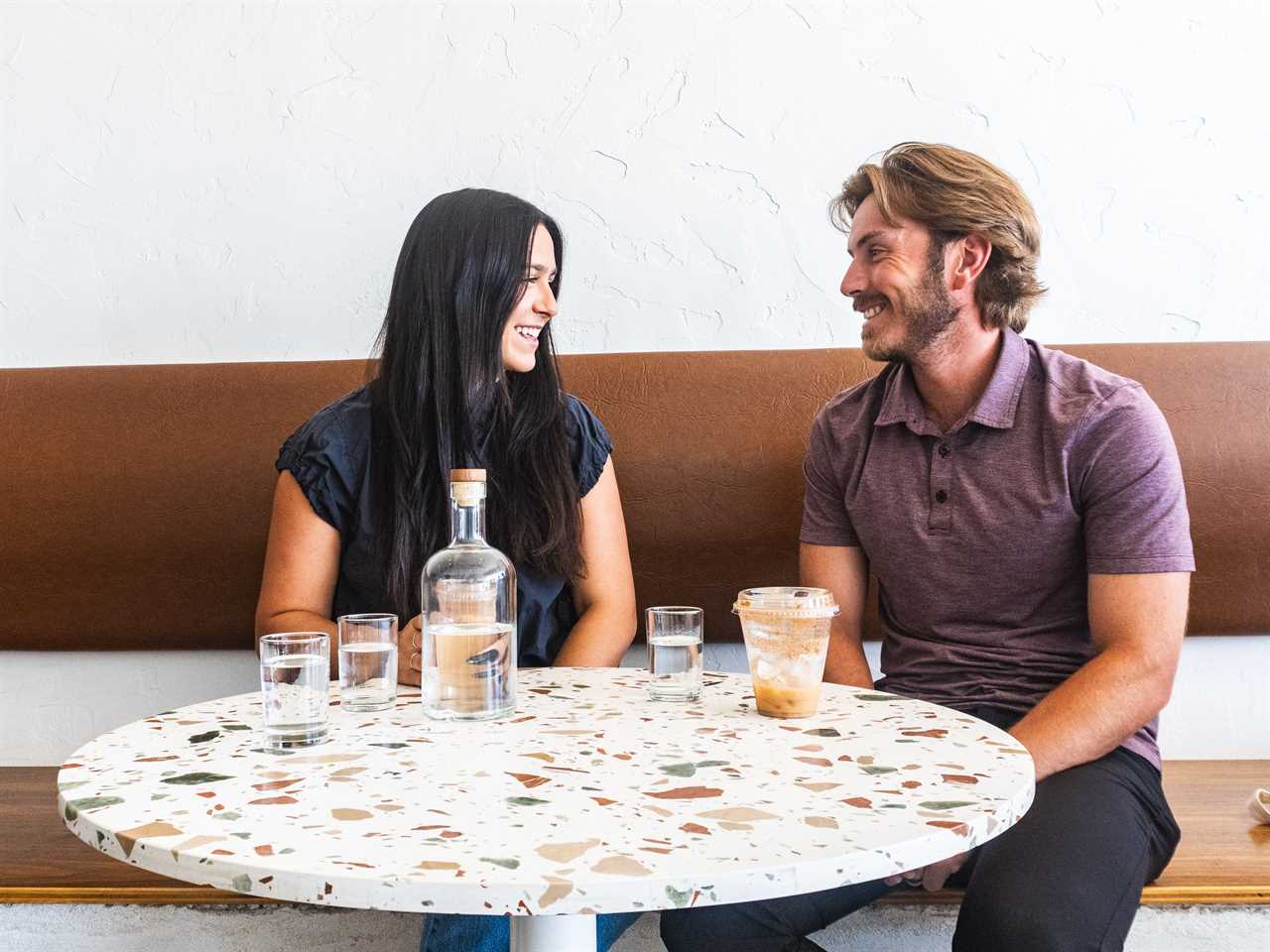 A young couple enjoying each other's company at a coffee shop.