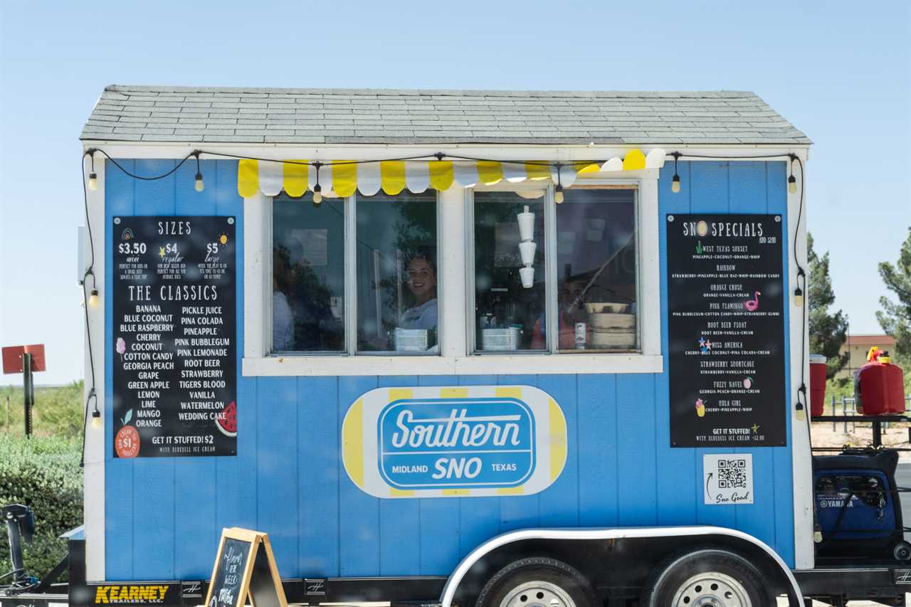 A snow cone stand featuring a young woman.