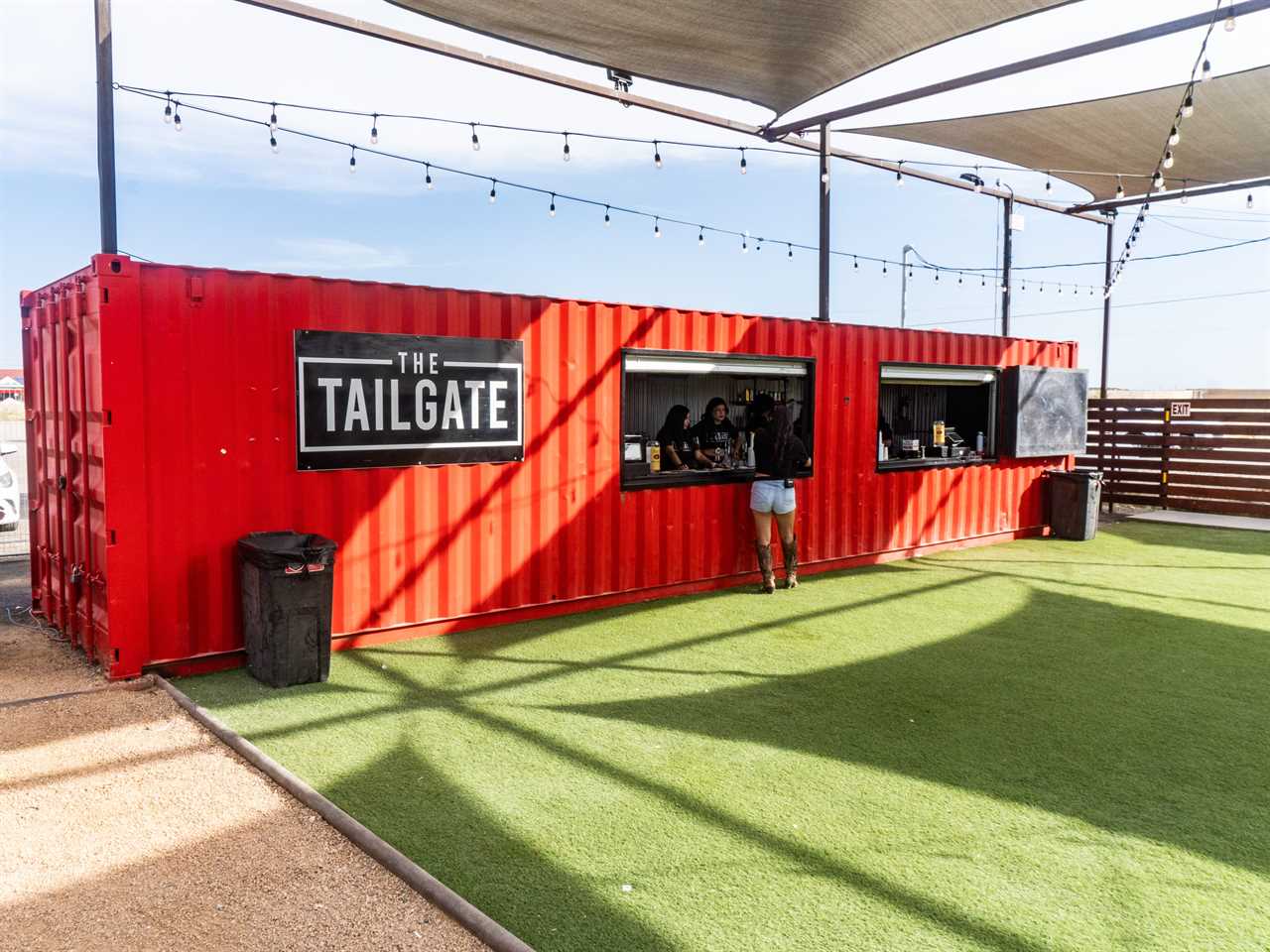 Tailgate employees working at a makeshift bar.