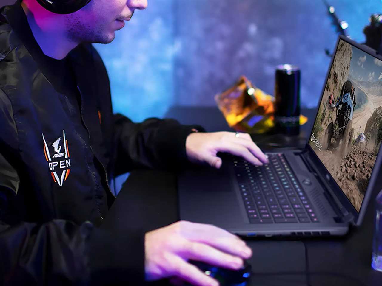 A person playing a racing game on a GIGABYTE gaming laptop.