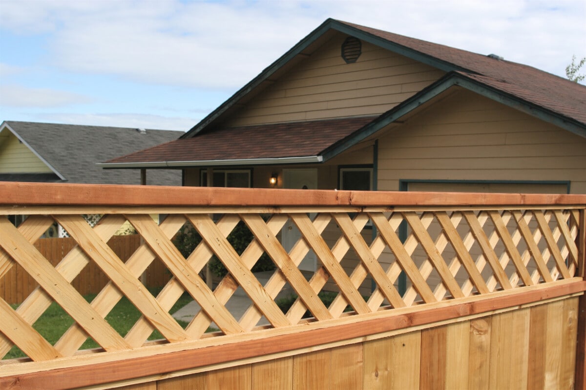 A new wooden privacy fence around a neighbors house