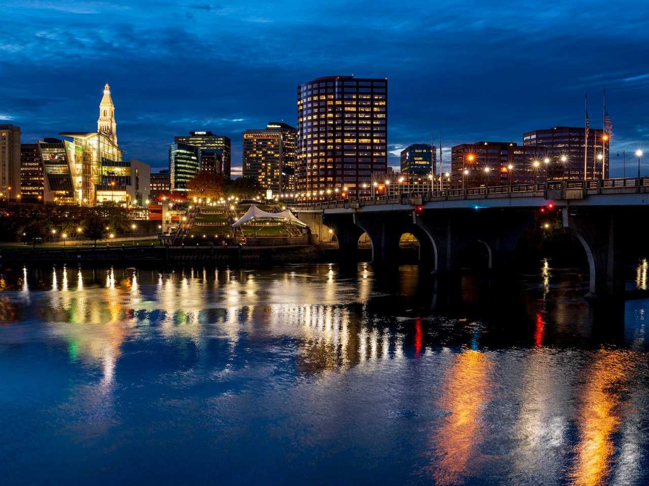 Skyline view of Hartford on Connecticut River with lights coming on, Connecticut.