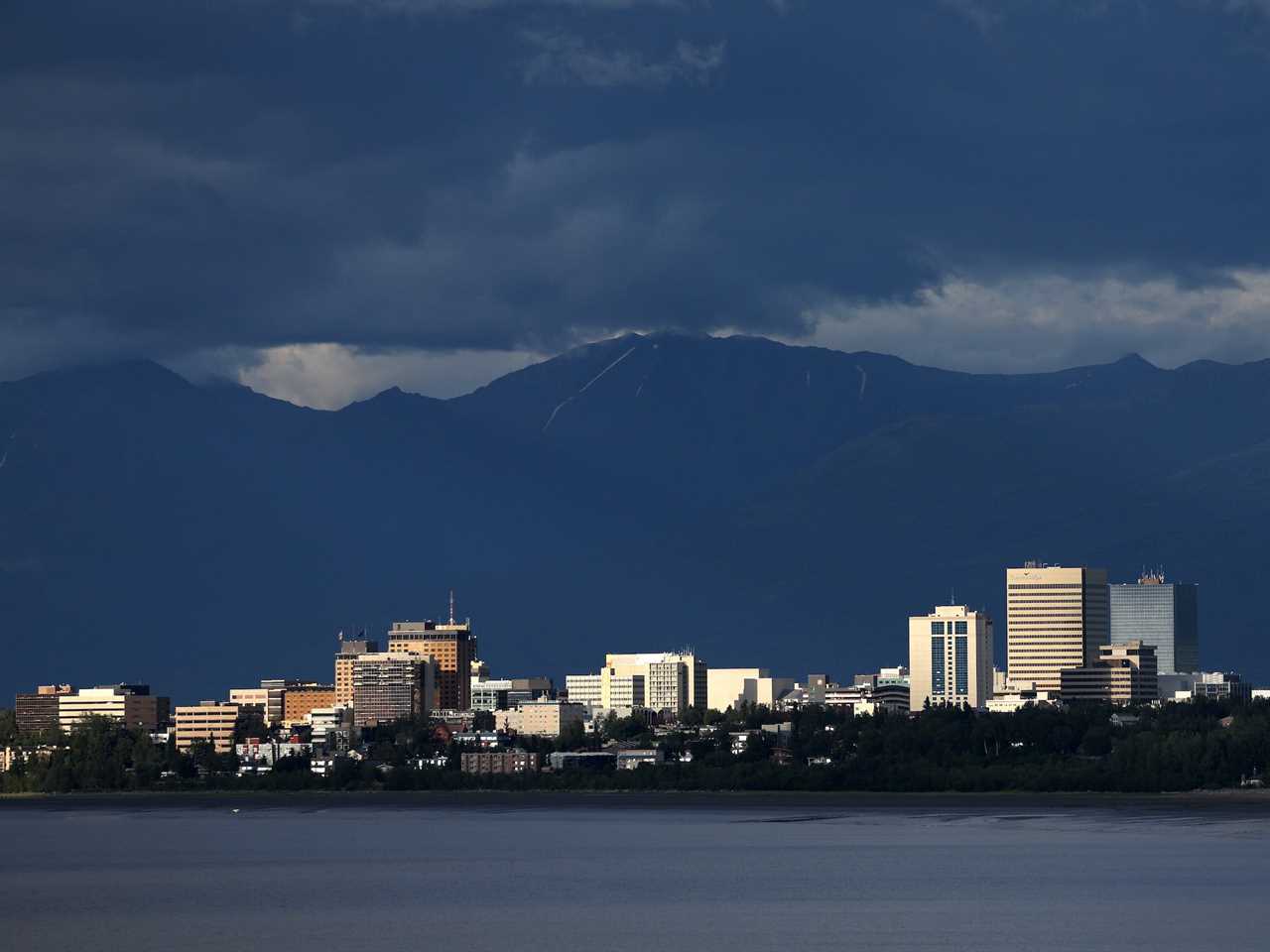 A view of the downtown skyline with mountains in the rear on July 10, 2022 in Anchorage, Alaska.