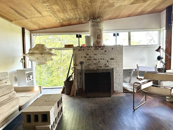 Original designs by Breuer, including cinder blocks stacked to form a coffee table and a Wassily chair, remain in the residence.