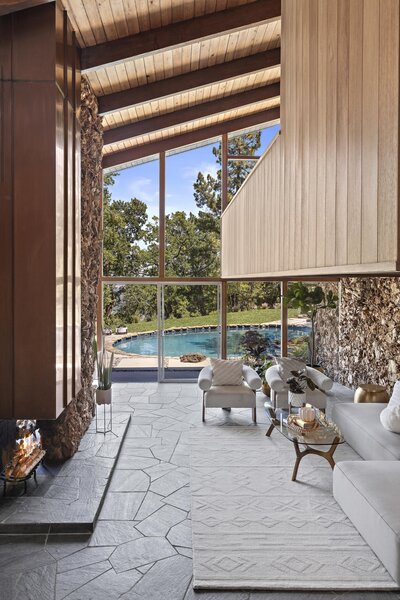 Original details can be found throughout the home's various levels, including the stone work, slate floors with radiant heat, and strawberry-blonde mahogany paneled walls.