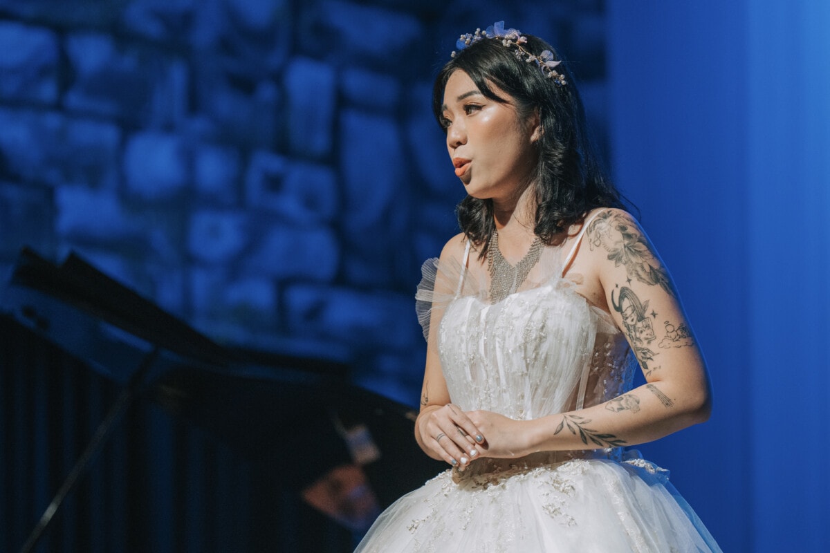 Young Female opera singer performing solo on stage