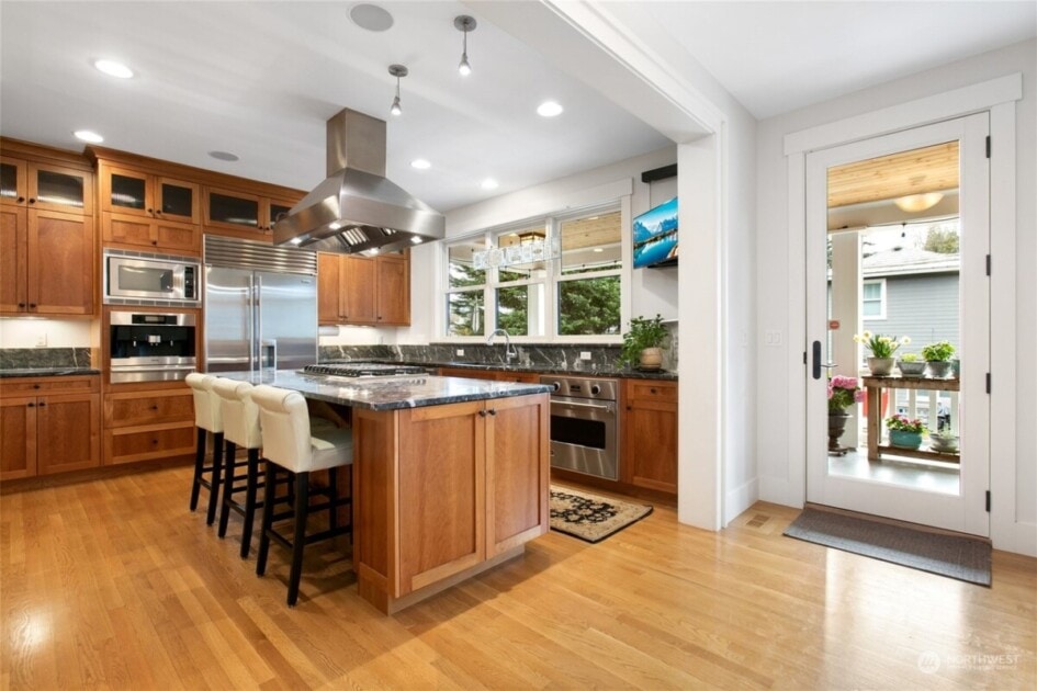 Kitchen with wood cabinets and black marble countertops