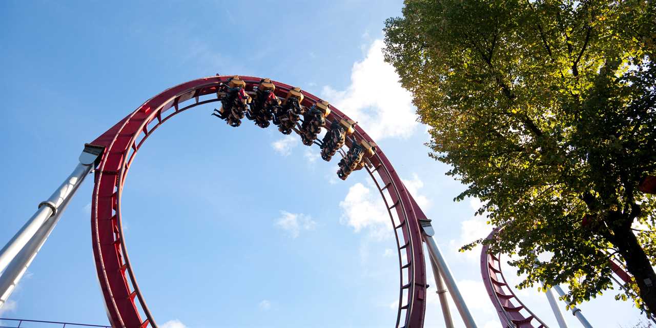 Low angle view of people at rollercoaster.