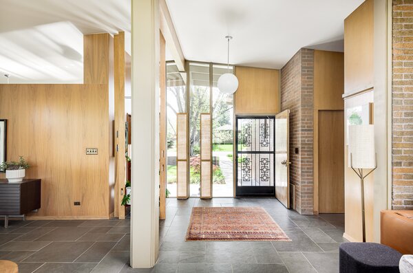 Designed by architect Richard Crowther, this 1957 home features handcrafted woodwork and floor-to-ceiling glazing from front to back.