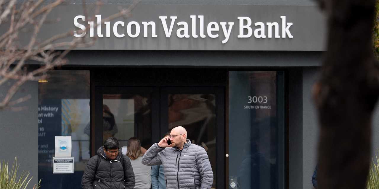 Employees stand outside of the shuttered Silicon Valley Bank (SVB) headquarters on March 10, 2023 in Santa Clara, California.