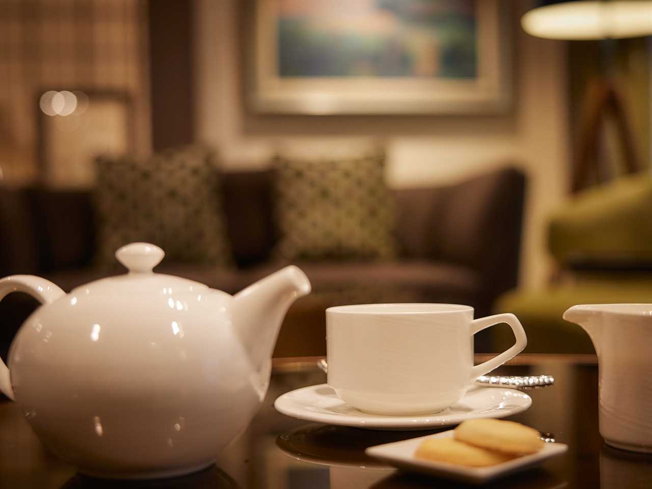 A teapot and a cup on a coffee table in a stateroom in The World.