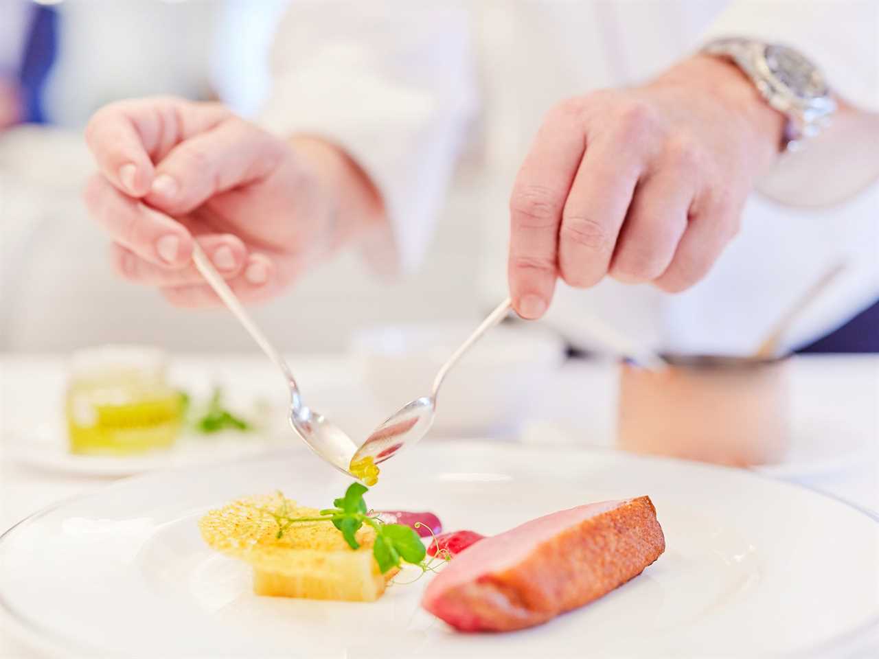 Someone plating up a meal aboard The World.