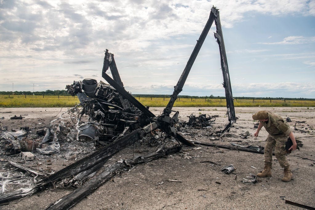 Ukrainian serviceman looks at fragments of the Russian military Ka-52 "Alligator" helicopter sestroyed by the Ukrainian army during Russia's invasion of Ukraine at the Gostomel airfield near Kyiv, Ukraine. July 08, 2022