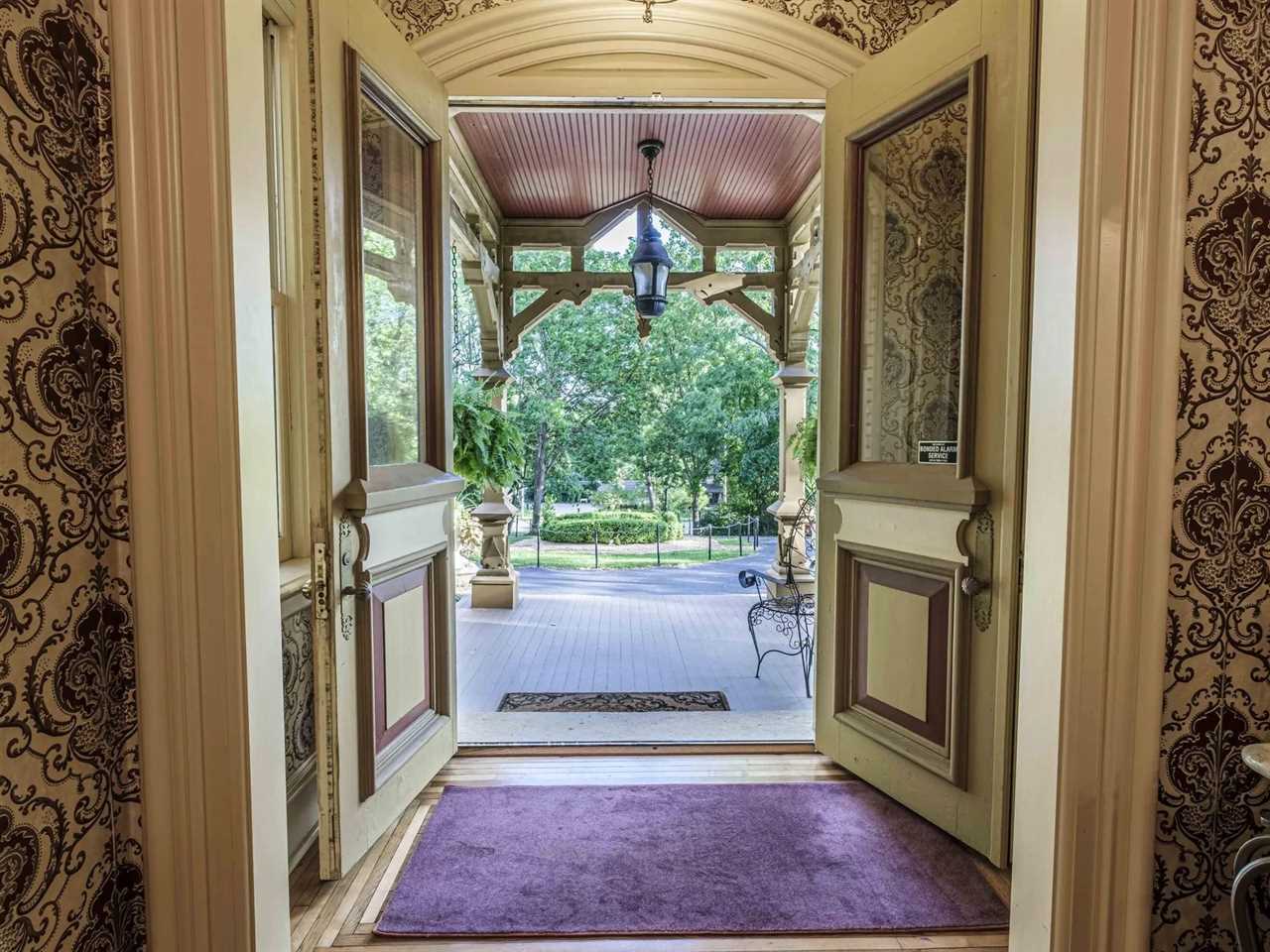 The front door of a mansion, opened.