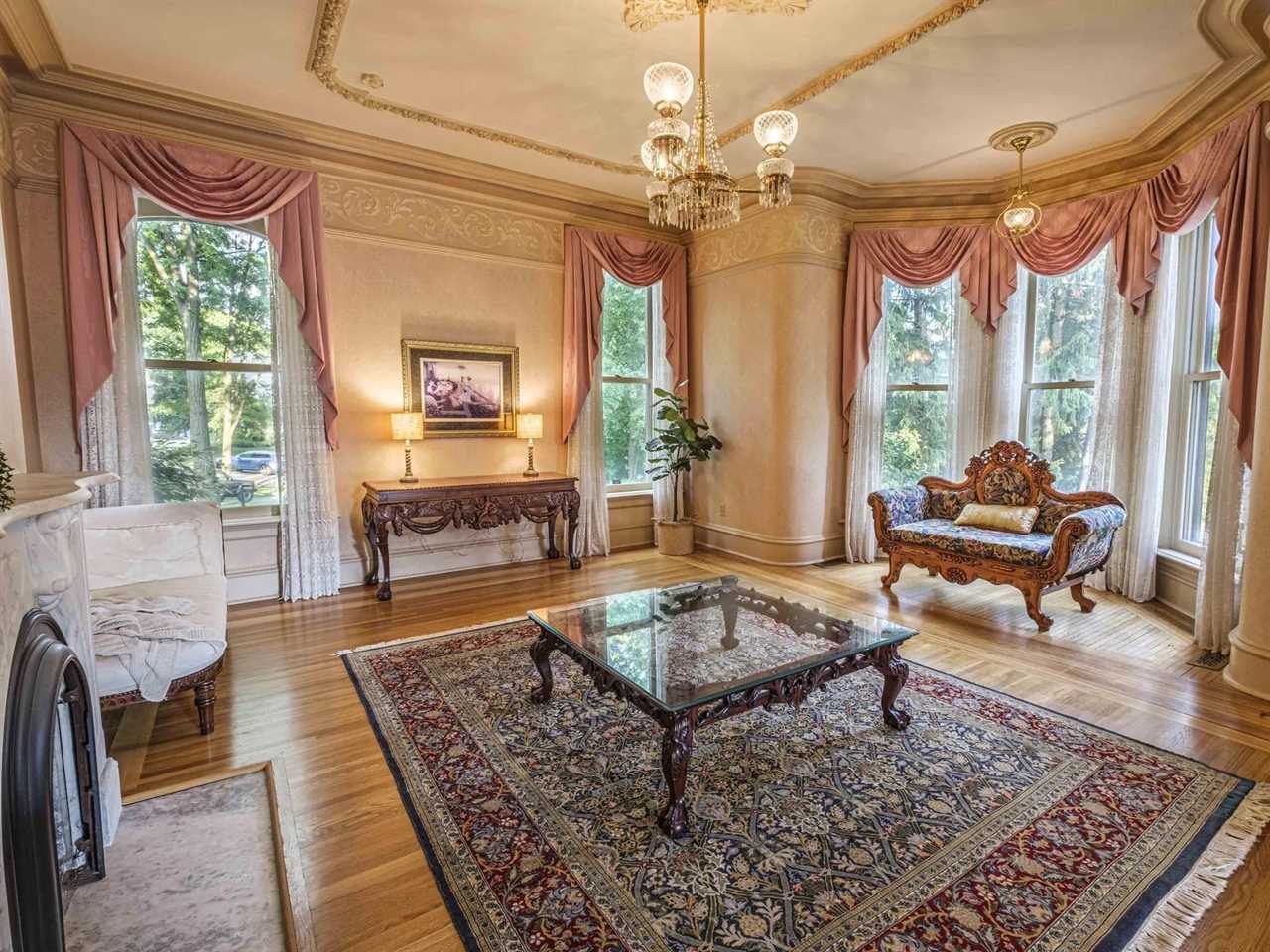 A living area with a marble fireplace.