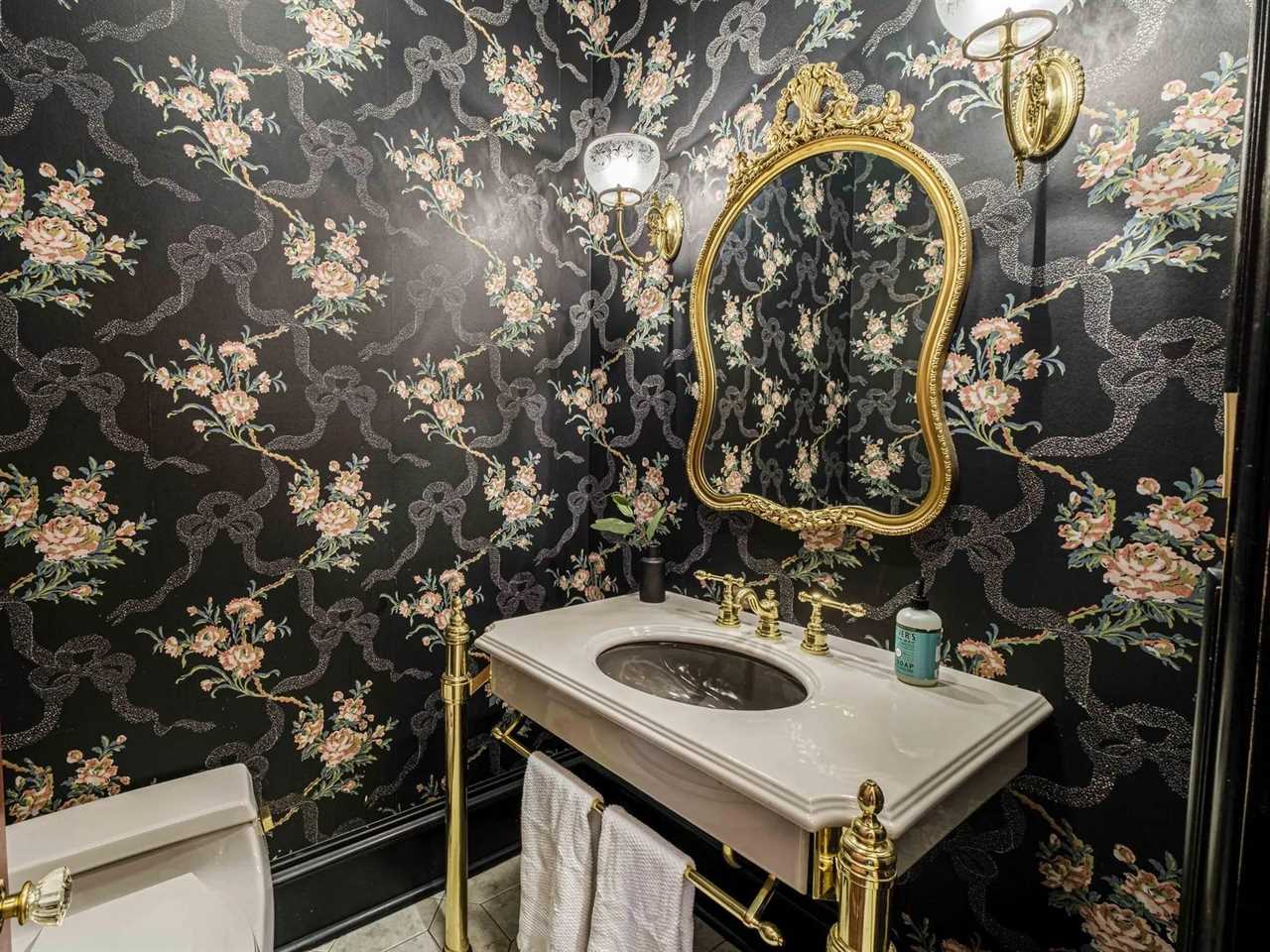 A powder room with printed wallpaper