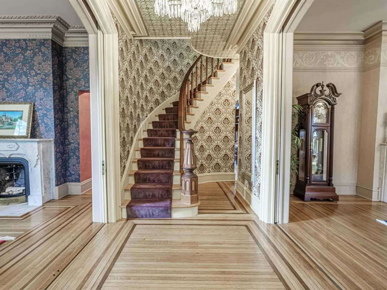 A staircase and two rooms on either side.