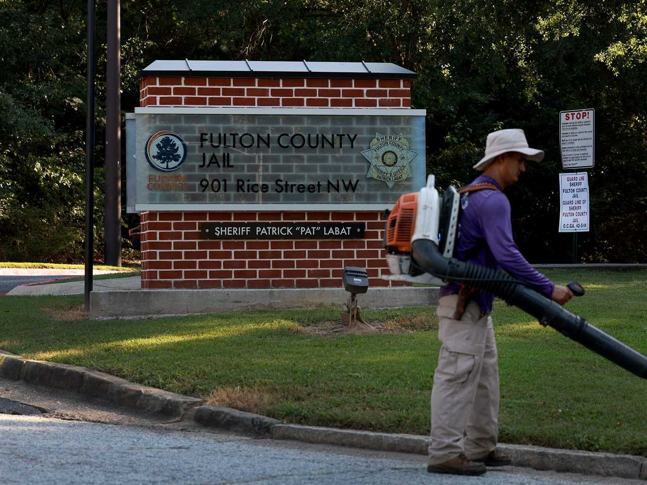 A landscaper works near one of the entrances to the Fulton County Jail on August 21, 2023 in Atlanta, Georgia.