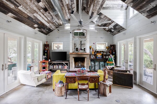 The vaulted ceilings in the main living areas enhance the overall sense of space, while the glass doors and large windows ensure plenty of natural light filters inside.