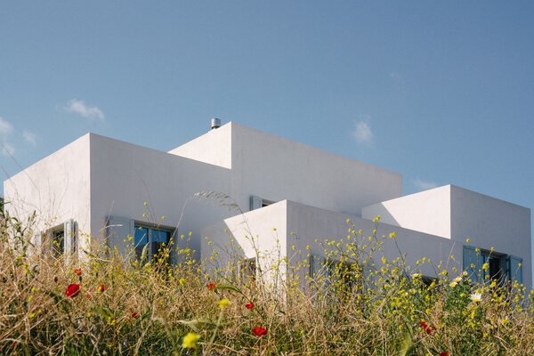 Similarly, from the grounds below, the home peeks out below in contrast with the sky.