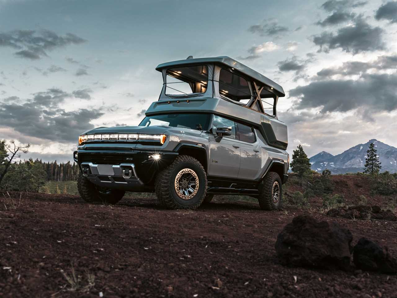 The GMC Hummer EV with EarthCruiser's upfit while parked in uneven terrain