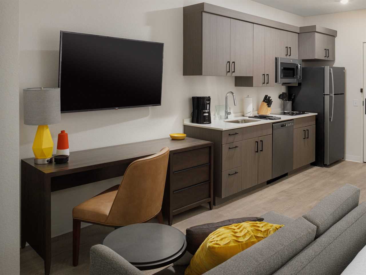 The kitchen and living room of a studio WaterWalk hotel room.