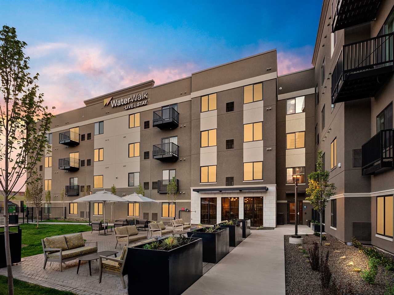 The exterior of the WaterWalk hotel in Meridian, Idaho with seating