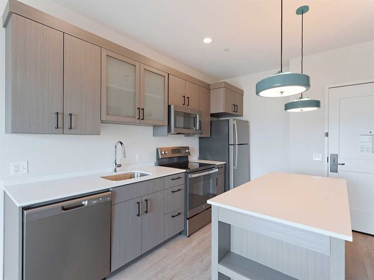 The kitchen of an unfurnished one-bedroom WaterWalk hotel room.